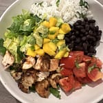 Chicken salad bowl with black beans, mango and avocado salsa and cilantro lime rice